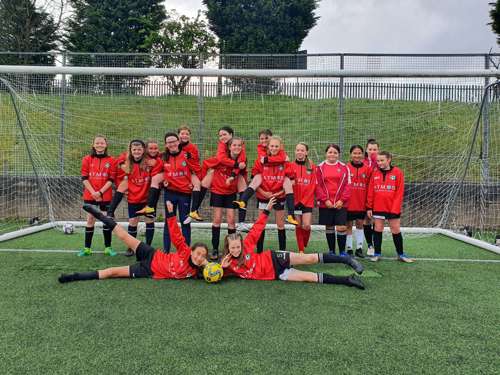 Haslingden Girls and Ladies Football Club wearing Atmos International sponsored training kit