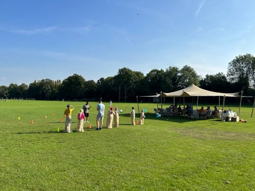 Atmos colleagues competing in a sack race