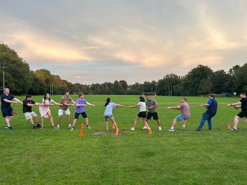 Atmos colleagues competing in a tug-o-war