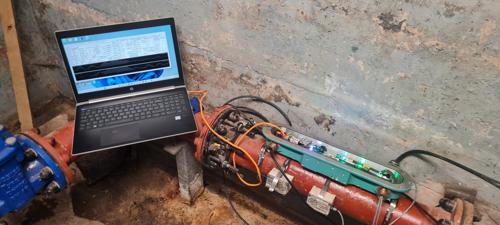 A laptop connected to hardware called Atmos Eclipse that supports single ended water leak detection using less instrumentation